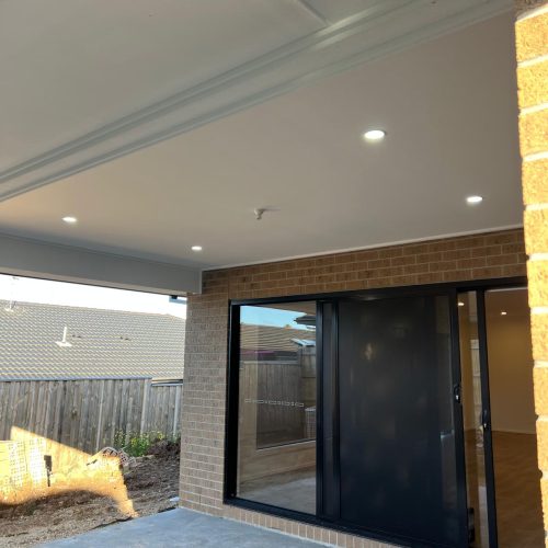 Covered alfresco area with ceiling downlights beside sliding glass doors